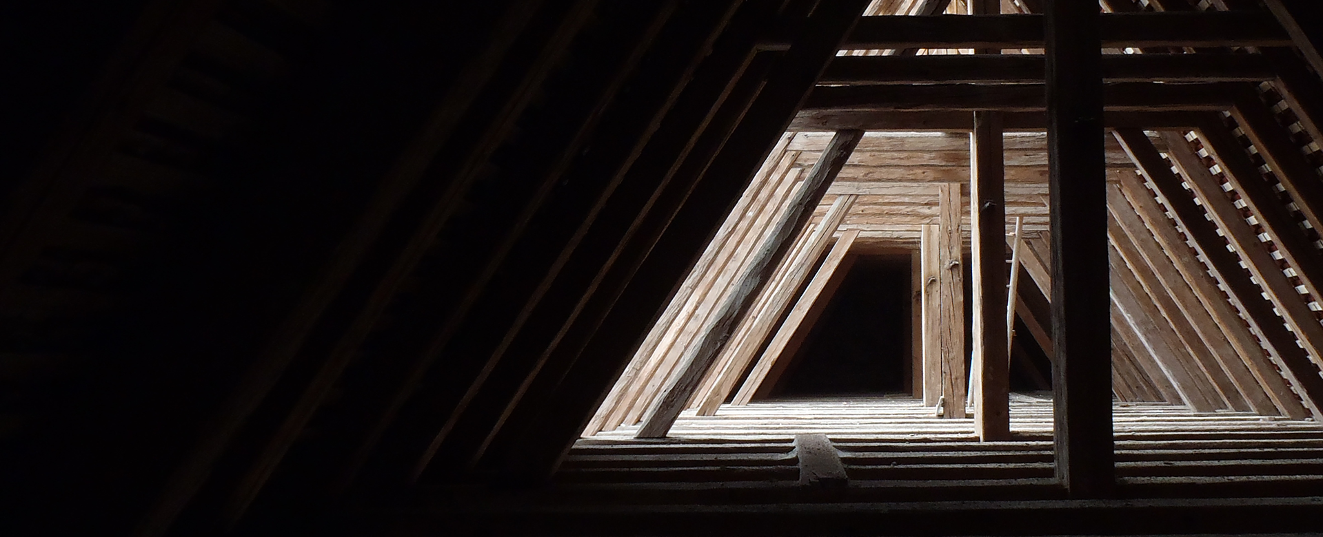 Wooden loft with an impressive interplay of light and shadow.