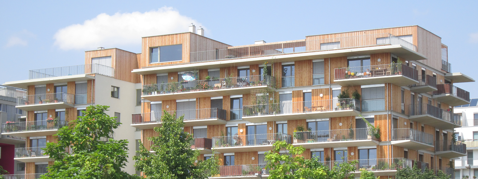Apartment block with a wooden façade on a pleasant spring day.