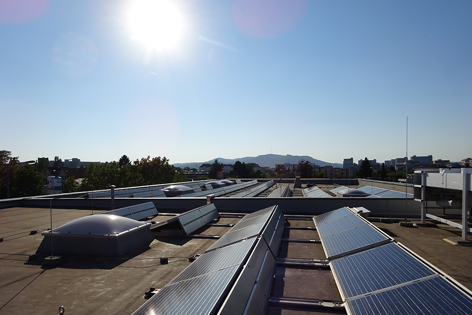 Photovoltaic systems shone on by the sun on a flat roof.